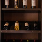 Wine bottles stored for display, but in a dark place, seemingly a closet.  