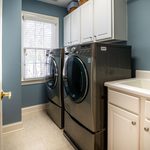 Front-loading washing machine  in a bright laundry room. Courtesy of Curtis Adams